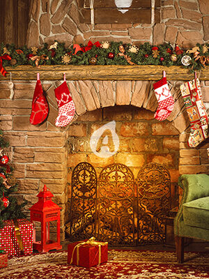 Christmas room with fireplace, an armchair and a Christmas tree with gifts