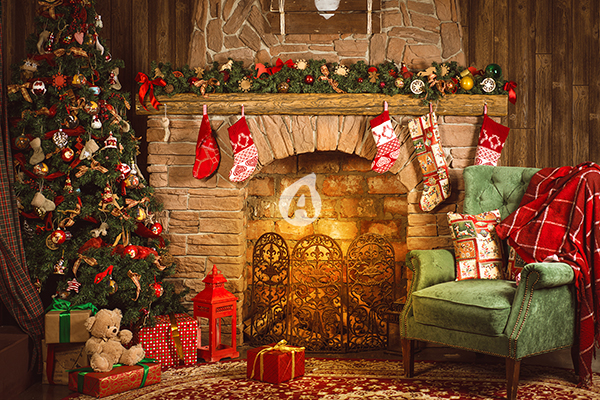 Christmas room with fireplace, an armchair and a Christmas tree with gifts